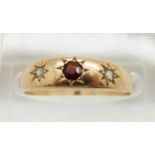 A 9ct gold ring set with a garnet and rose cut diamonds in a star setting, 2.8g, size N