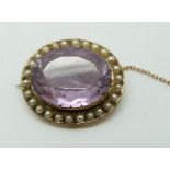 Edwardian 9ct gold brooch set with an oval cut amethyst and seed pearls (2.5 x 2cm)