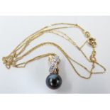 A 14k gold pendant set with a pearl and diamonds, 1.7g