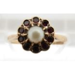 A 9ct gold ring set with a pearl surrounded by garnets, 2g, size M