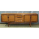 A retro G Plan sideboard comprising four drawers flanked by cupboards, W212 x D47 x H80cm