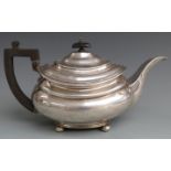 Georgian hallmarked silver teapot raised on four ball feet with ebonised handle, London circa 1830