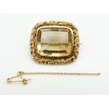 Victorian gold brooch set with a mixed cut citrine within a scrolling border, 10.5g, 3 x 2.6cm