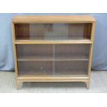 Gordon Russell or similar light oak bookcase with glazed sliding doors, W93 x D24 x H95cm