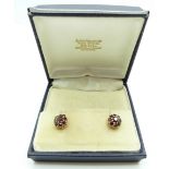 A pair of 9ct gold earrings set with clusters of garnets