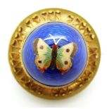 Victorian brooch set with an enamel butterfly on a blue guilloché enamel ground, verso glass
