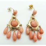 A pair of 9ct gold earrings set with five pear drop coral beads and two coral cabochons to each