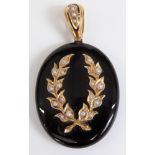 Victorian black enamel pendant set with seed pearls in a foliate design, verso a glass locket