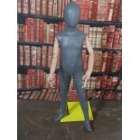 Haberdashery/shopfitting modern articulated child mannequin supported by a removable steel column to