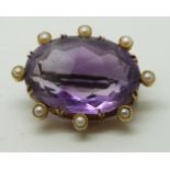 Victorian/Edwardian brooch set with a large oval cut amethyst surrounded by seed pearls