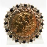 A 1982 gold half sovereign set into a 9ct gold ring set with paste set border, 12.2g size L