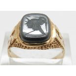 A 9ct gold ring set with a haematite intaglio, 4.4g, size T