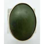 A 9ct gold ring set with a large nephrite jade cabochon, 11.7g, size O