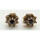 A pair of 9ct gold earrings set with sapphires and diamonds