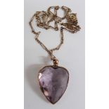 Edwardian pendant set with a large heart cut amethyst, 2.5cm long on a 9ct gold chain, 9.9g,