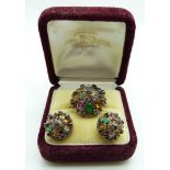 A yellow metal ring set with sapphires, citrine, topaz, garnet, tiger's eye, etc in a large cluster,