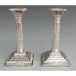 Edward VII pair of silver Corinthian column candlesticks with reeded columns and stepped and