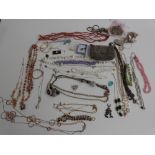 A collection of costume jewellery including beads, pendants, tiger's eye bracelet, etc