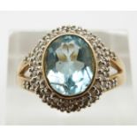 A 9ct gold ring set with oval cut aquamarine and diamonds, 4.8g, size U