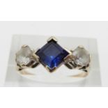 A 9ct gold ring set with a synthetic sapphire and paste, 3.2g, size O