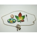 A silver maple leaf brooch set with enamel, silver necklace, silver cameo, cloisonné brooch and a