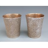 Pair of retro style hallmarked silver beakers with bark effect finish, London 2003 with 999 grade