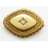 Victorian Etruscan Revival gold  brooch set with an old mine cut diamond measuring approximately 0.