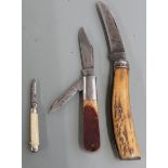 Three vintage penknives, two with horn handles, one stamped Barlow, one with Sayner to blade