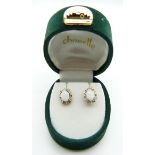 A pair of 9ct gold earrings set with opals and diamonds