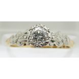 An 18ct gold ring set with a round cut diamond of approximately 0.4ct in a platinum setting, in