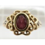 A 9ct gold ring set with an oval cut garnet, 2.8g, size P
