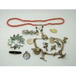 Silver charm bracelet, coral necklace, silver brooch etc.