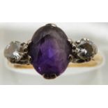 An 18ct gold ring set with an oval cut amethyst and two diamonds of approximately 0.2ct, 3g, size O