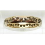 A 9ct gold eternity ring set with paste in a zig zag design, 1.8g, size L