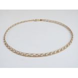 An 18ct gold necklace set with pearls in plaited setting, 10g