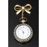 Silver gilt keyless winding open faced pocket watch on 9ct gold ribbon brooch with pearl set case,