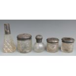 Five Victorian and later hallmarked silver topped dressing table pots and bottles, height of tallest