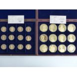 Two cased sets of gold plated commemorative coins comprising 12 x 50mm "Portraits of The Queen"