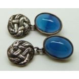 A pair of silver cufflinks set with blue agate cabochons