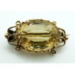 Victorian brooch set with an oval cut citrine within scrolling border, 5.4g, 2.8 x 1.3cm