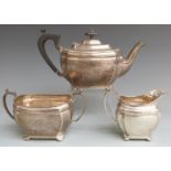 George V hallmarked silver three piece teaset of bulbous design with incuse corners, Sheffield