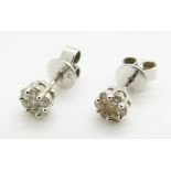 A pair of 18ct white gold earrings set with diamonds in clusters