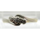 An 18ct gold ring set with three diamonds in a platinum setting, 2.6g, size O