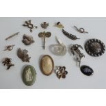 A quantity of silver brooches including Wedgwood, marcasite etc