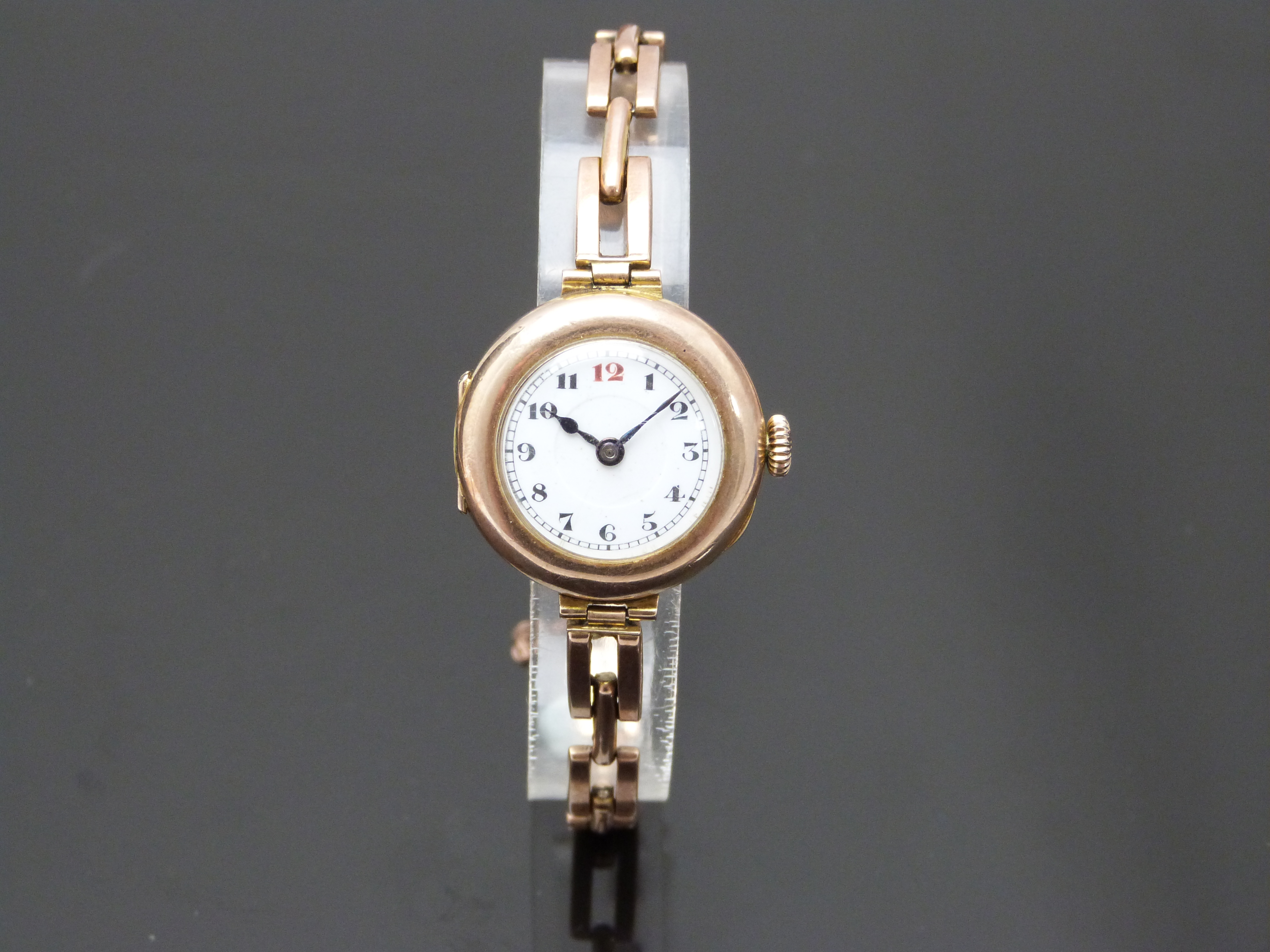 Edwardian 9ct gold ladies wristwatch with blued hands, black Arabic numerals, railroad minute track,