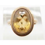 A 9ct gold ring set with an oval cut citrine, 4.6g, size N