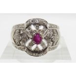 An 18ct white gold ring set with a ruby and diamonds, 6.8g, size N