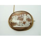 Victorian yellow metal brooch set with a cameo depicting a winged god being pulled by horses, 5.7