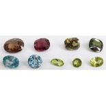 Nine cut gemstones including tourmaline, garnet, quartz, peridot and zircon