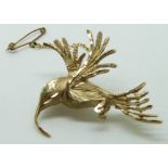 A 9ct gold brooch in the form of a hummingbird with an emerald eye, 6.2g